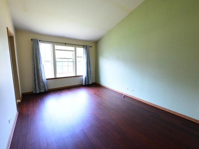 1740 Somerfield Ln, Crystal Lake, IL 60014 - empty room featuring dark wood finished floors, baseboards, and lofted ceiling