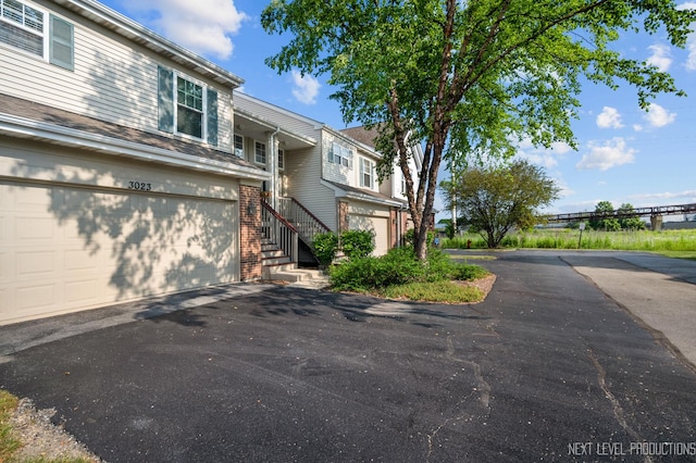 3023 Saganashkee Ln, Naperville, IL 60564 - view of front of property with driveway, brick siding, and a garage
