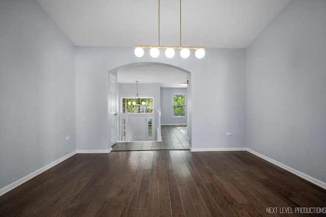 3023 Saganashkee Ln, Naperville, IL 60564 - spare room with arched walkways, hardwood / wood-style floors, and baseboards