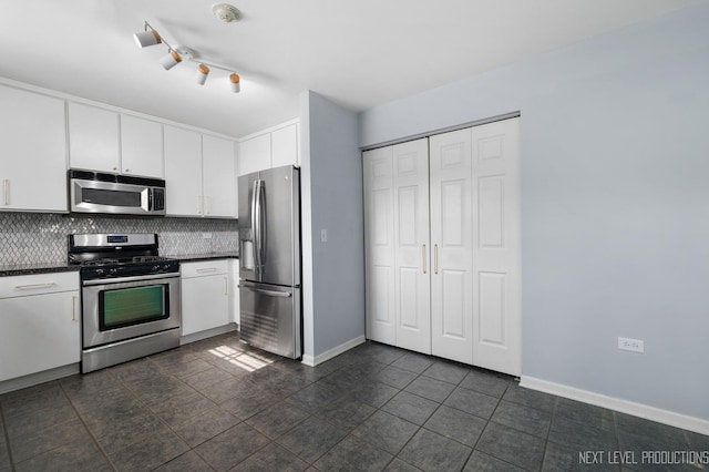 3023 Saganashkee Ln, Naperville, IL 60564 - kitchen featuring stainless steel appliances, dark countertops, decorative backsplash, white cabinetry, and baseboards