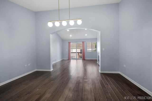 3023 Saganashkee Ln, Naperville, IL 60564 - spare room featuring arched walkways, dark wood finished floors, and baseboards
