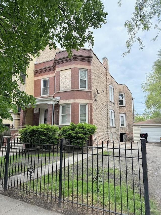 7621 S Normal Ave, Chicago, IL 60620 - view of front of property featuring brick siding, a fenced front yard, and a garage