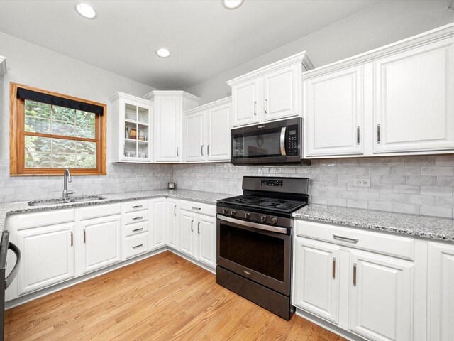 3445 W 114th St, Chicago, IL 60655 - kitchen featuring black microwave, stainless steel gas stove, a sink, white cabinets, and tasteful backsplash