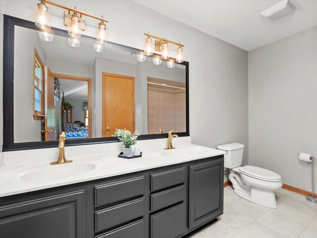 3445 W 114th St, Chicago, IL 60655 - ensuite bathroom featuring toilet, double vanity, a shower, tile patterned flooring, and baseboards