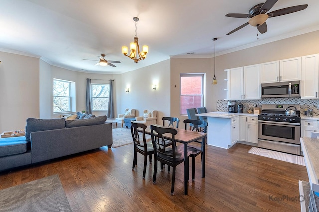 4520 S King Dr Unit 4B, Chicago, IL 60653 - dining area featuring ceiling fan, dark wood finished floors, a chandelier, and crown molding