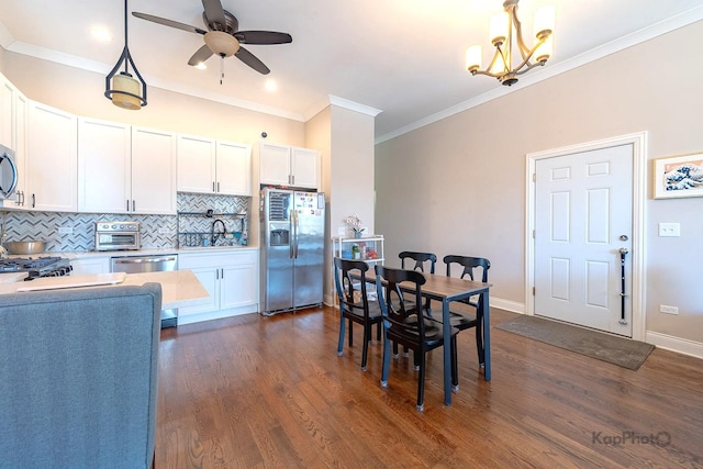 4520 S King Dr Unit 4B, Chicago, IL 60653 - dining room featuring ornamental molding, dark wood finished floors, ceiling fan, a chandelier, and baseboards