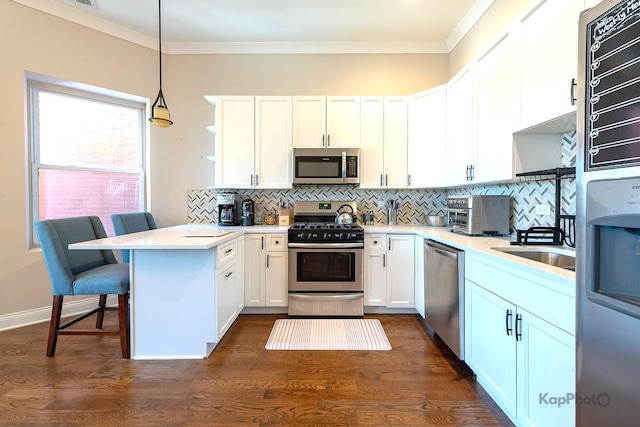 4520 S King Dr Unit 4B, Chicago, IL 60653 - kitchen with stainless steel appliances, a peninsula, open shelves, white cabinetry, and crown molding