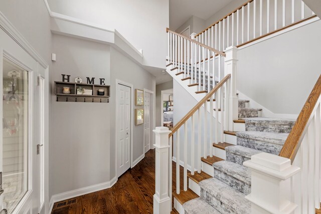 12433 Dublin Ln, Plainfield, IL 60585 - stairs with wood finished floors, a towering ceiling, and baseboards