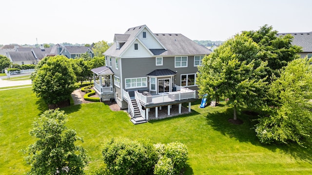 12433 Dublin Ln, Plainfield, IL 60585 - back of house featuring a wooden deck, a yard, a standing seam roof, and board and batten siding