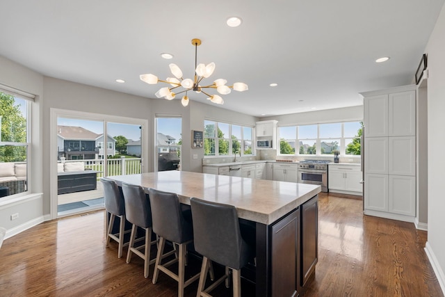 12433 Dublin Ln, Plainfield, IL 60585 - kitchen with stainless steel appliances, a kitchen island, a chandelier, white cabinetry, and recessed lighting