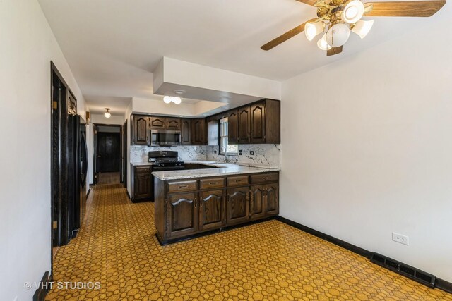 5341 S Austin Ave, Chicago, IL 60638 - kitchen featuring stainless steel microwave, a sink, black range oven, and dark brown cabinets