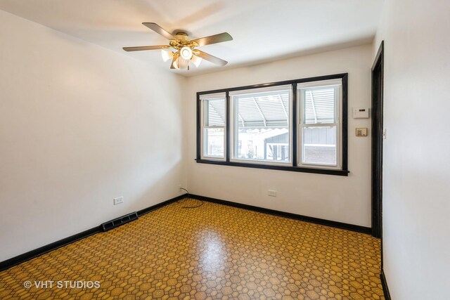 5341 S Austin Ave, Chicago, IL 60638 - empty room featuring a ceiling fan and baseboards