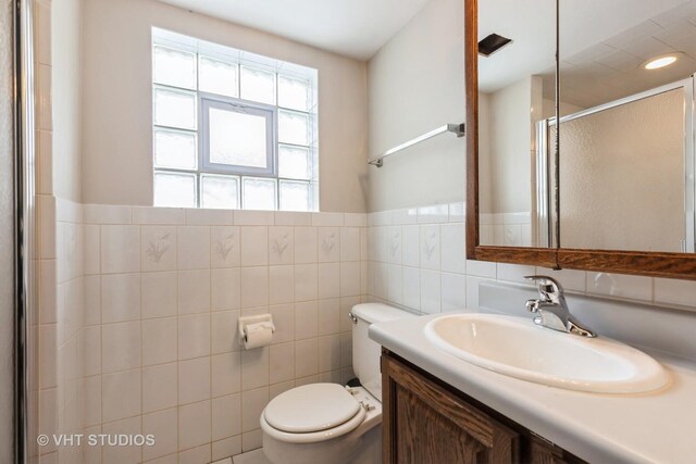 5341 S Austin Ave, Chicago, IL 60638 - full bath with toilet, a shower stall, vanity, tile walls, and a wainscoted wall