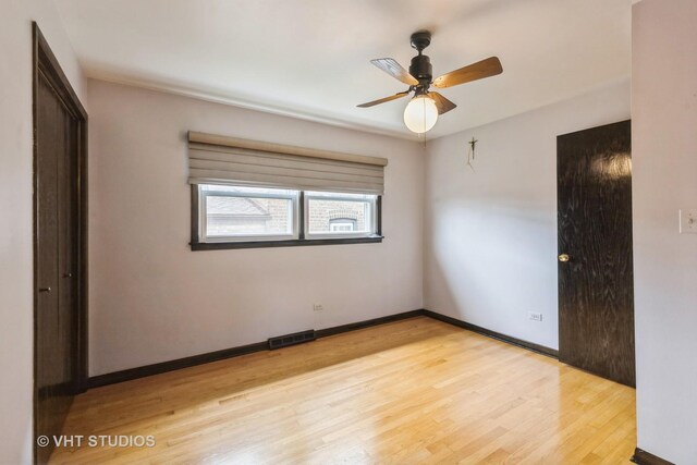 5341 S Austin Ave, Chicago, IL 60638 - unfurnished bedroom featuring light wood-style flooring, baseboards, and a ceiling fan