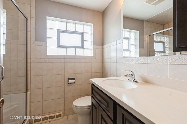 5341 S Austin Ave, Chicago, IL 60638 - bathroom featuring toilet, a stall shower, vanity, tile walls, and tile patterned floors