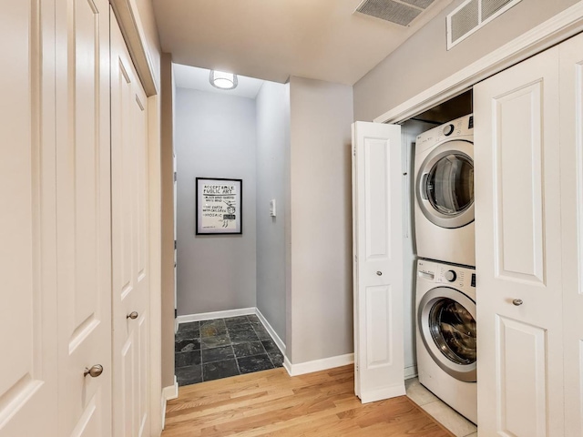 834 N Wood St Unit 2N, Chicago, IL 60622 - washroom with stacked washing machine and dryer, baseboards, and light wood-style floors