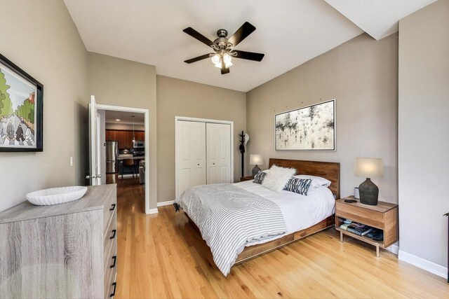834 N Wood St Unit 2N, Chicago, IL 60622 - bedroom with freestanding refrigerator, light wood finished floors, a closet, and baseboards