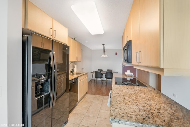 800 Elgin Rd Unit 806, Evanston, IL 60201 - kitchen featuring black appliances, light brown cabinetry, light tile patterned floors, and hanging light fixtures