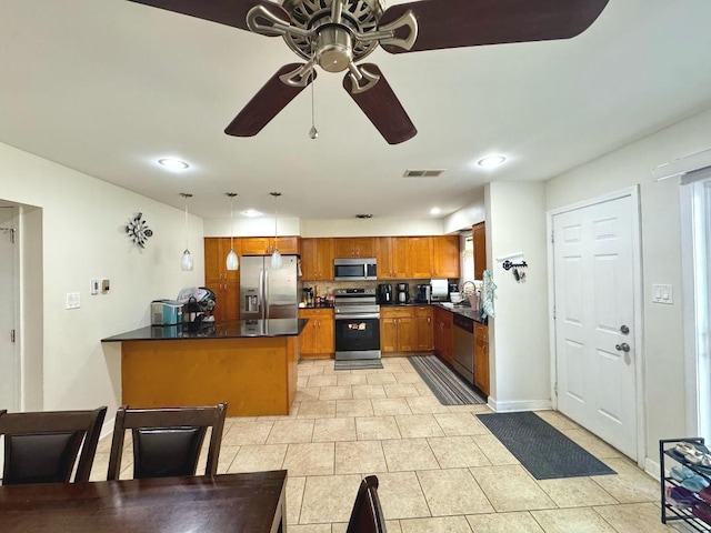 1S215 Stratford Ln, Villa Park, IL 60181 - kitchen featuring stainless steel appliances, dark countertops, a peninsula, brown cabinets, and a ceiling fan