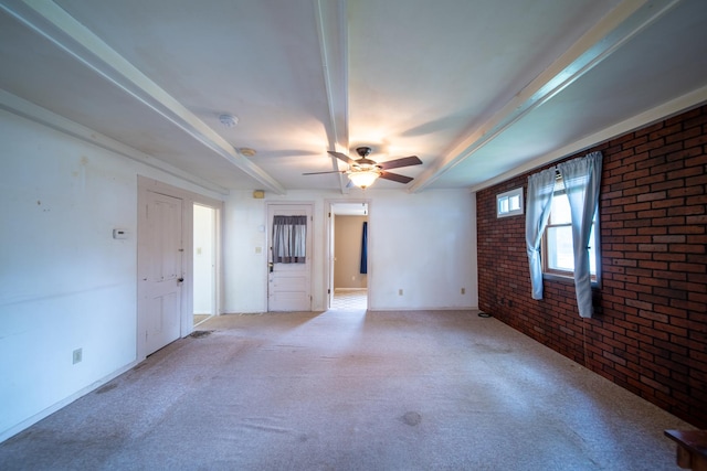521 Armeida St, Dixon, IL 61021 - spare room featuring brick wall, beam ceiling, ceiling fan, light colored carpet, and a smoke detector