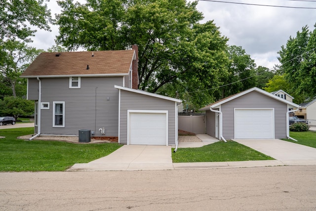 521 Armeida St, Dixon, IL 61021 - view of side of home featuring concrete driveway, a chimney, a lawn, and a detached garage