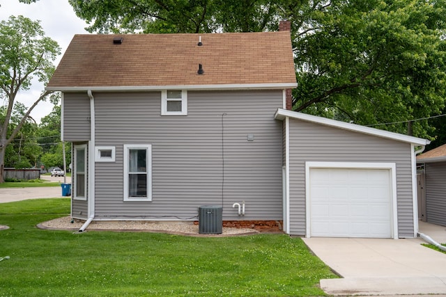 521 Armeida St, Dixon, IL 61021 - view of side of home featuring a yard, a chimney, an attached garage, roof with shingles, and concrete driveway
