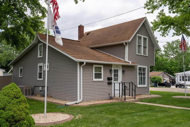 521 Armeida St, Dixon, IL 61021 - back of house with a chimney, a yard, and a shingled roof
