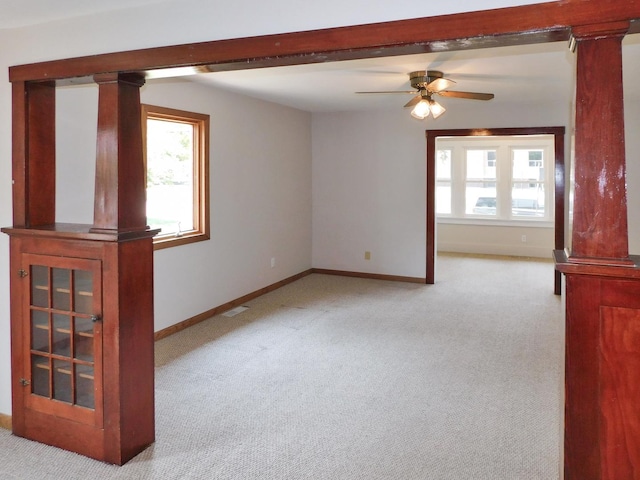 829 Blackhawk Blvd, South Beloit, IL 61080 - unfurnished room featuring carpet flooring, baseboards, ceiling fan, and decorative columns