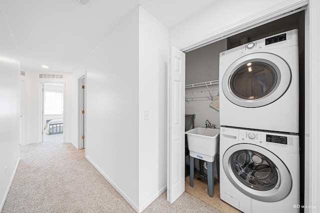 10651 Gabrielle Ln, Orland Park, IL 60462 - laundry room featuring stacked washer / dryer, baseboards, and light colored carpet