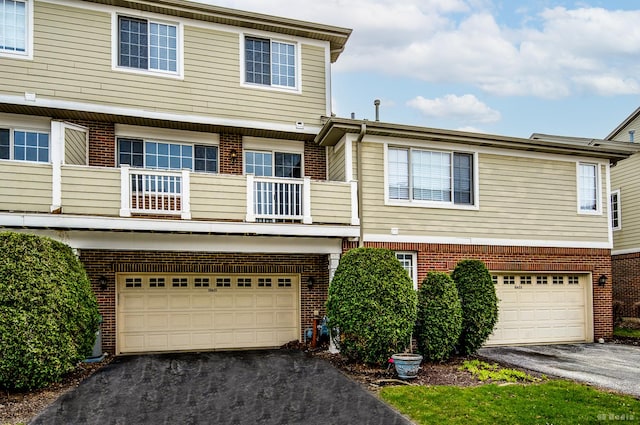10651 Gabrielle Ln, Orland Park, IL 60462 - townhome / multi-family property featuring brick siding, driveway, a balcony, and a garage