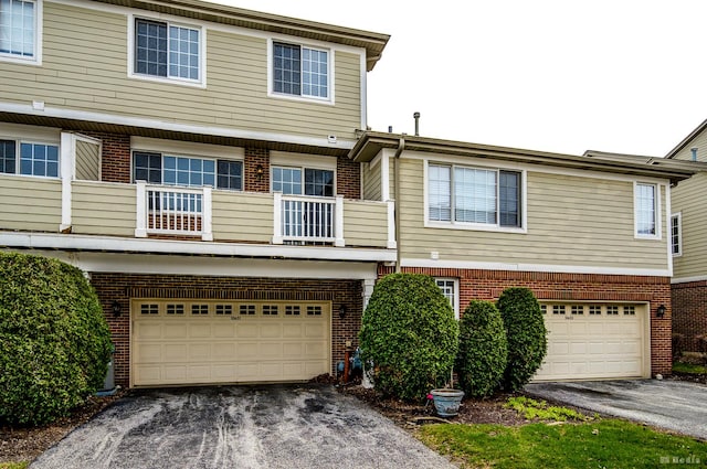 10651 Gabrielle Ln, Orland Park, IL 60462 - view of property featuring asphalt driveway, brick siding, a garage, and a balcony