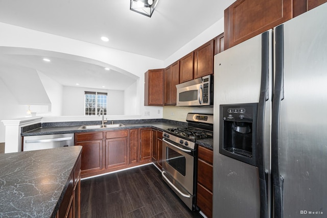 10651 Gabrielle Ln, Orland Park, IL 60462 - kitchen featuring stainless steel appliances, a sink, dark wood-style floors, arched walkways, and recessed lighting