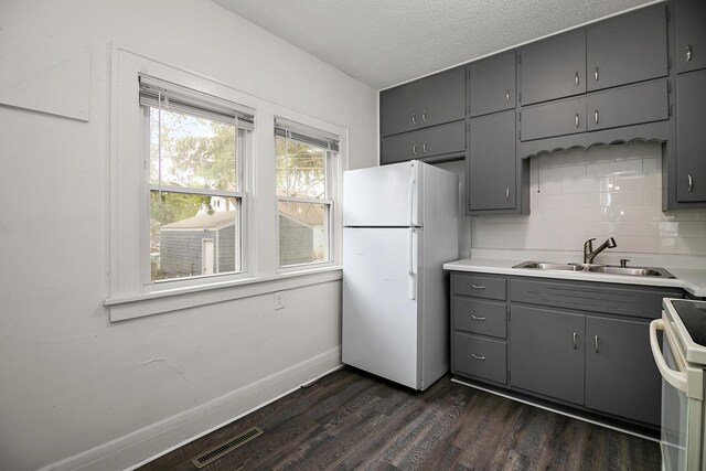 487 S Lincoln Ave, Kankakee, IL 60901 - kitchen featuring freestanding refrigerator, gray cabinetry, a sink, dark wood-style flooring, and range with electric stovetop