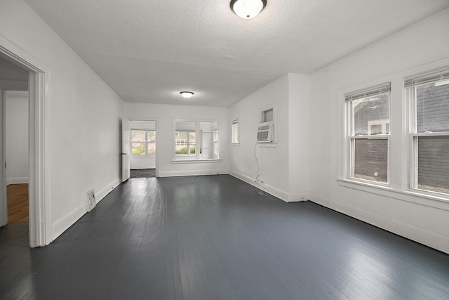 487 S Lincoln Ave, Kankakee, IL 60901 - unfurnished living room featuring baseboards, dark wood-style floors, a textured ceiling, and cooling unit