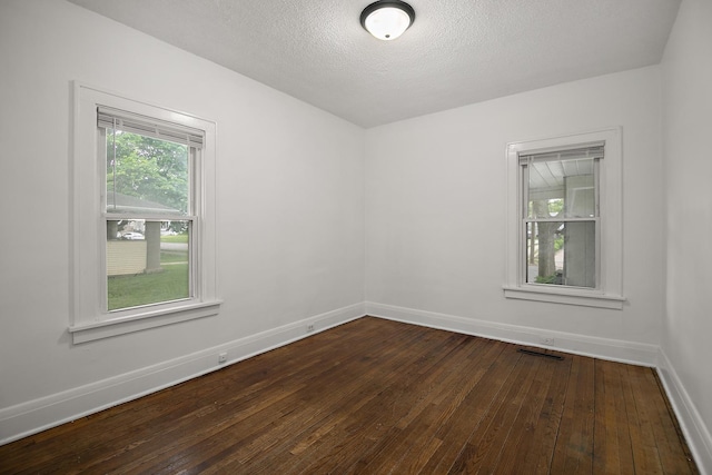 487 S Lincoln Ave, Kankakee, IL 60901 - unfurnished room featuring dark wood-style flooring, baseboards, and a textured ceiling
