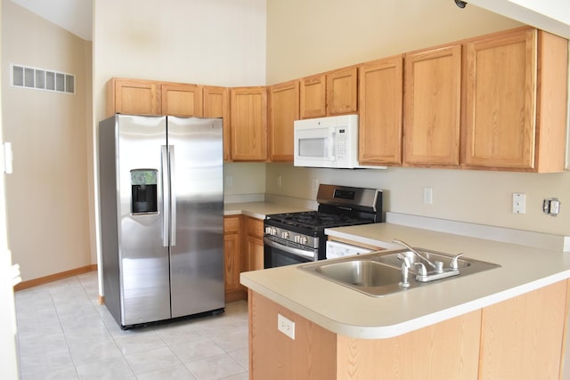 14635 Euclid St Unit D, Cedar Lake, IN 46303 - kitchen featuring appliances with stainless steel finishes, a sink, light countertops, a peninsula, and light tile patterned floors