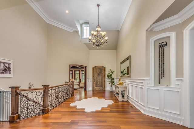 217 Haman Rd, Inverness, IL 60010 - foyer with a chandelier, a towering ceiling, wood finished floors, ornamental molding, and wainscoting