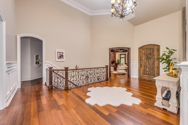 217 Haman Rd, Inverness, IL 60010 - foyer with a high ceiling, a chandelier, wood finished floors, ornamental molding, and wainscoting