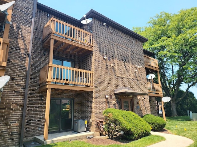 2238 Abbeywood Dr Unit C, Lisle, IL 60532 - back of house with a balcony, brick siding, and central air condition unit
