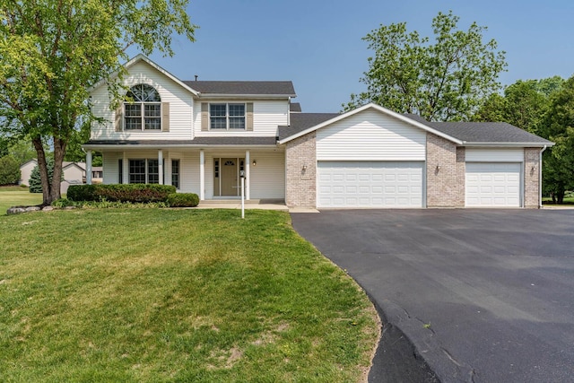 5804 Targee Trl, Roscoe, IL 61073 - traditional-style home with asphalt driveway, an attached garage, a front lawn, covered porch, and brick siding