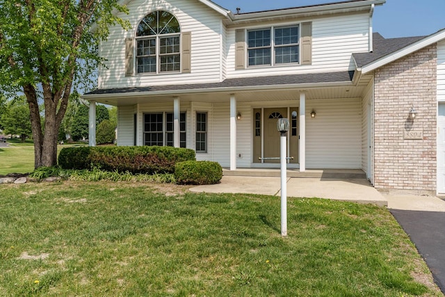 5804 Targee Trl, Roscoe, IL 61073 - view of front facade featuring covered porch and a front yard