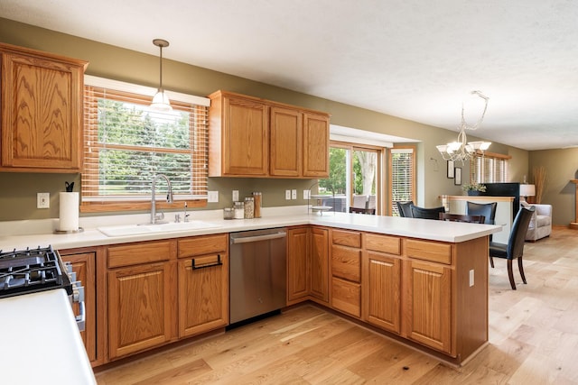 5804 Targee Trl, Roscoe, IL 61073 - kitchen with appliances with stainless steel finishes, a sink, light wood-type flooring, a peninsula, and a chandelier