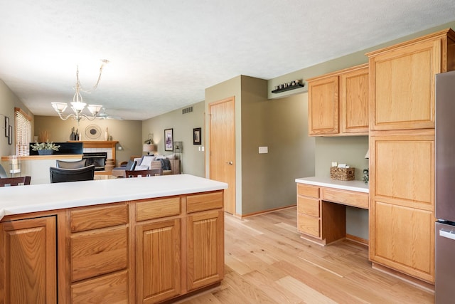 5804 Targee Trl, Roscoe, IL 61073 - kitchen featuring light wood-style floors, light countertops, a chandelier, open floor plan, and a textured ceiling