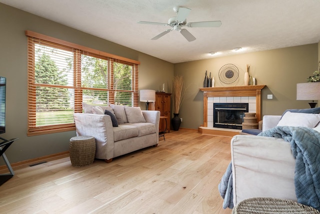 5804 Targee Trl, Roscoe, IL 61073 - living area featuring light wood finished floors, a ceiling fan, a fireplace, and baseboards