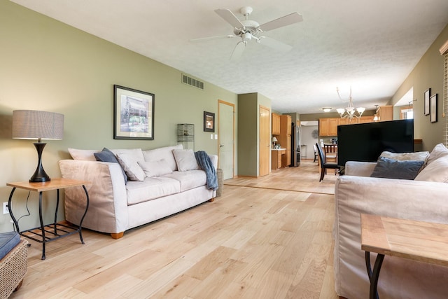 5804 Targee Trl, Roscoe, IL 61073 - living area with a chandelier, light wood finished floors, and a ceiling fan