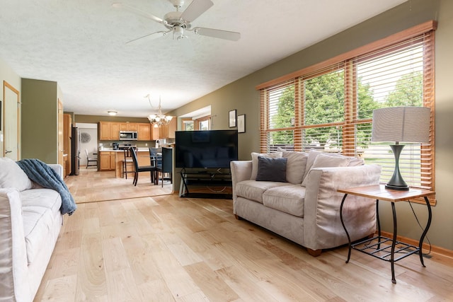 5804 Targee Trl, Roscoe, IL 61073 - living room with light wood-type flooring, a chandelier, and ceiling fan