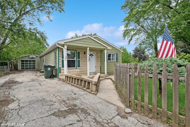 908 Diana Ct, Round Lake Beach, IL 60073 - view of front facade featuring asphalt driveway, an outbuilding, and a detached garage