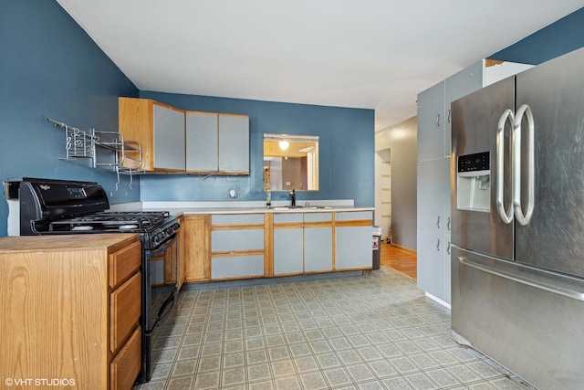 908 Diana Ct, Round Lake Beach, IL 60073 - kitchen with stainless steel fridge with ice dispenser, black range with gas stovetop, light countertops, a sink, and baseboards