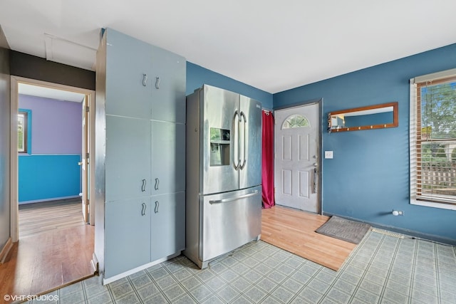 908 Diana Ct, Round Lake Beach, IL 60073 - kitchen with stainless steel fridge, wood finished floors, and baseboards