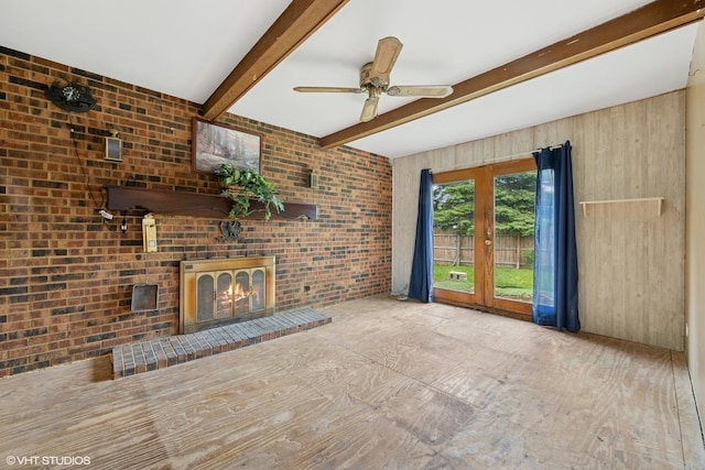 908 Diana Ct, Round Lake Beach, IL 60073 - unfurnished living room featuring a fireplace, beam ceiling, ceiling fan, brick wall, and wood walls
